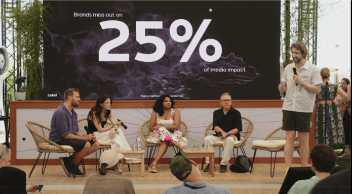 image of a speakers panel of five seated on a stage