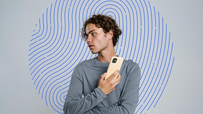 image of man looking sideways holding phone
