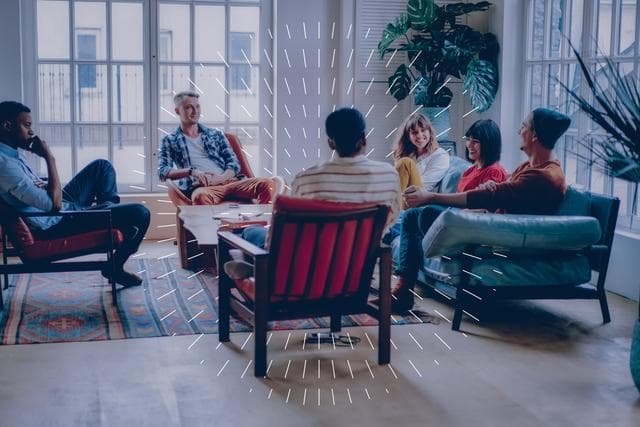 people sitting on armchairs in a room discussing 