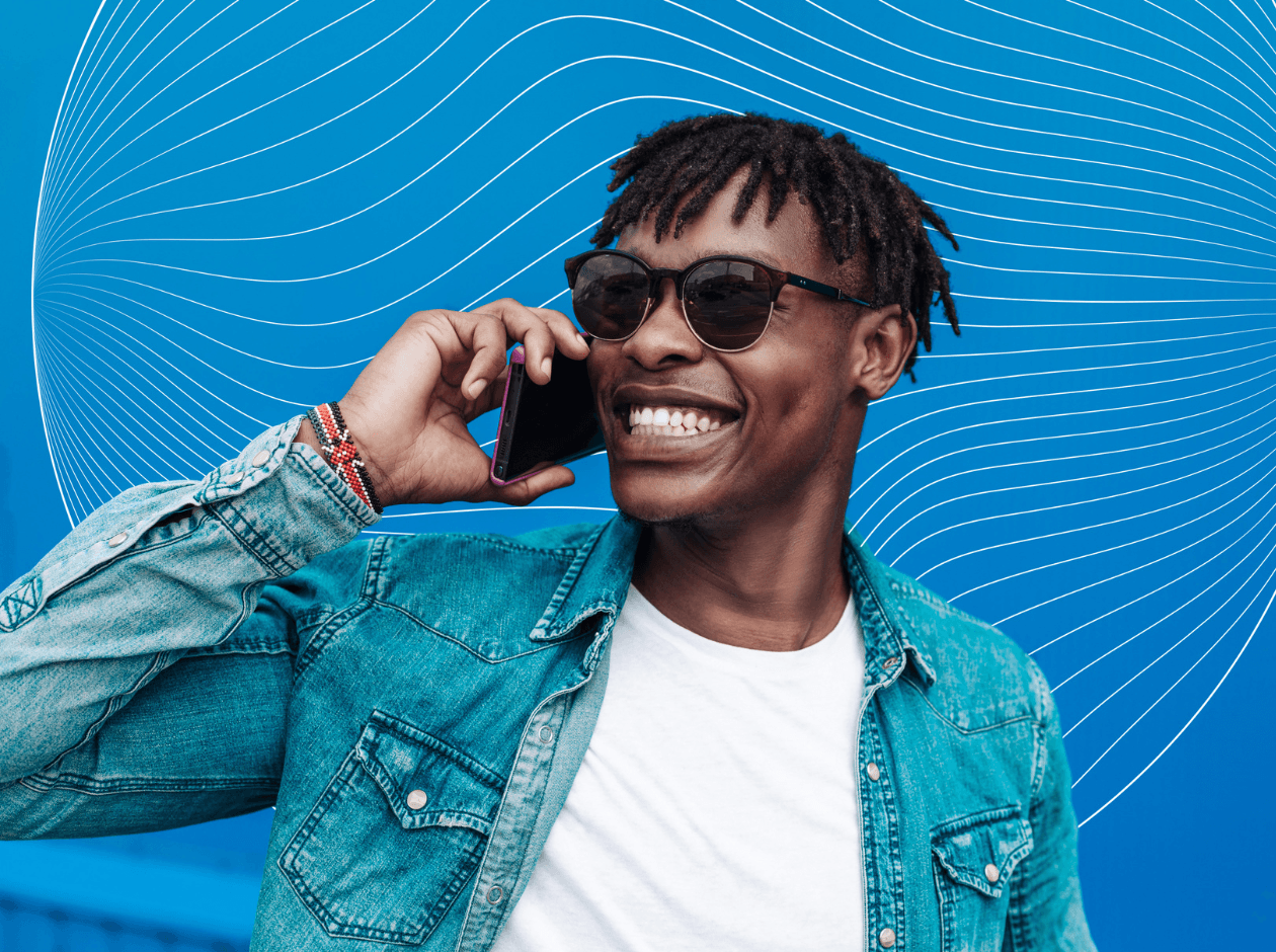 Black man speaking and smiling on mobile phone