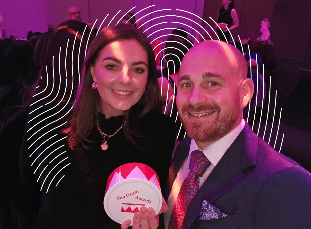 Man and woman holding Drum Marketing Award