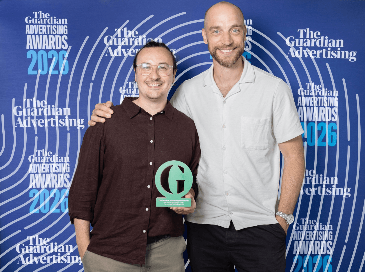 Two men holding awards