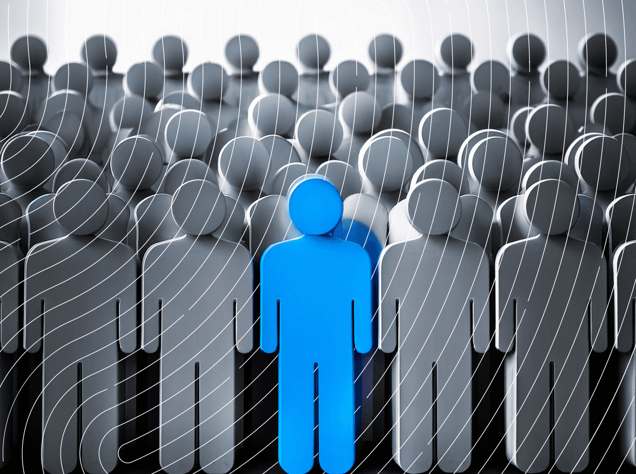 One blue figure among a sea of grayscale silhouettes