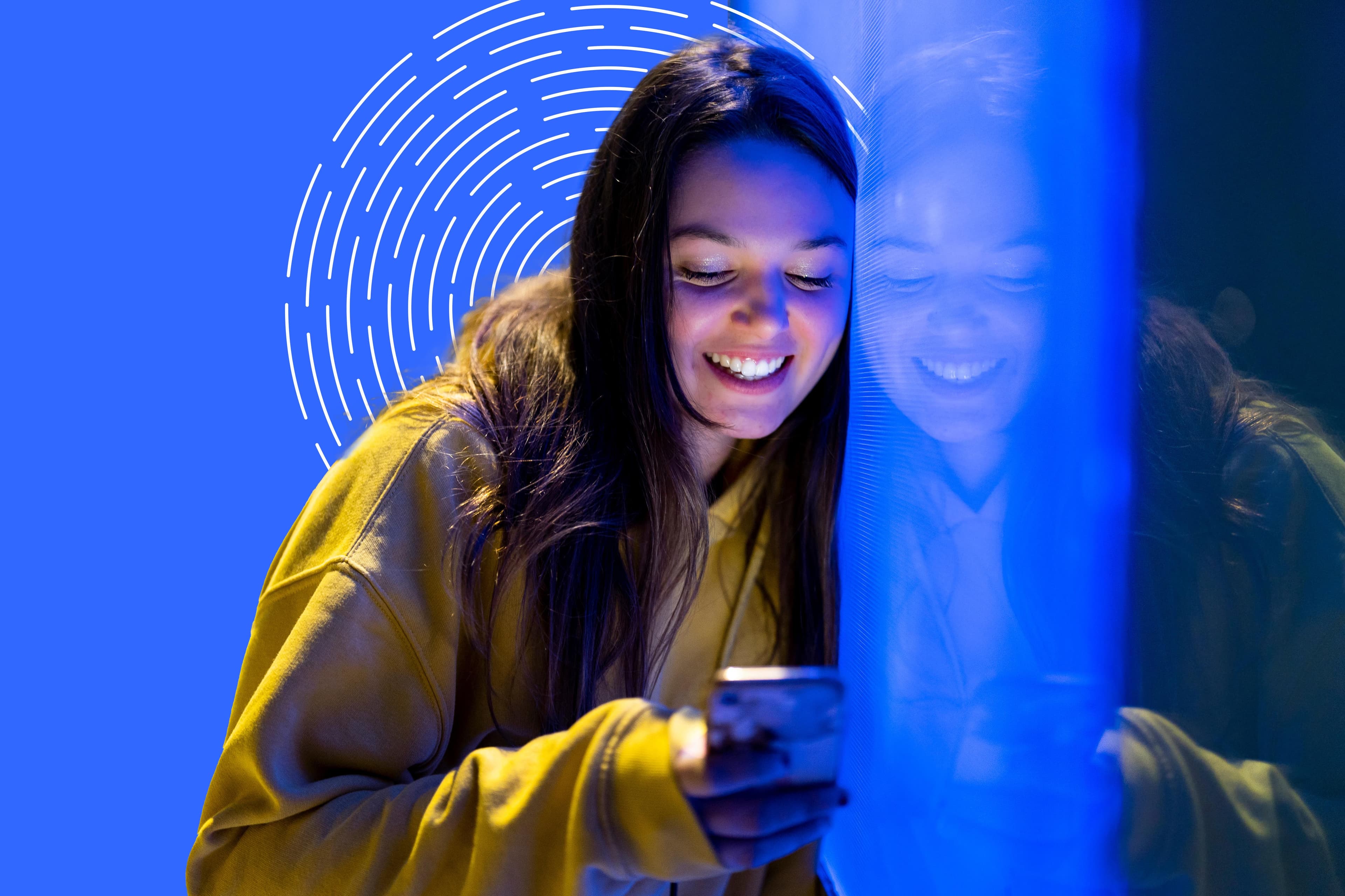 woman smiling looking at phone