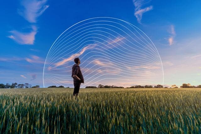 man looking at sky in a field