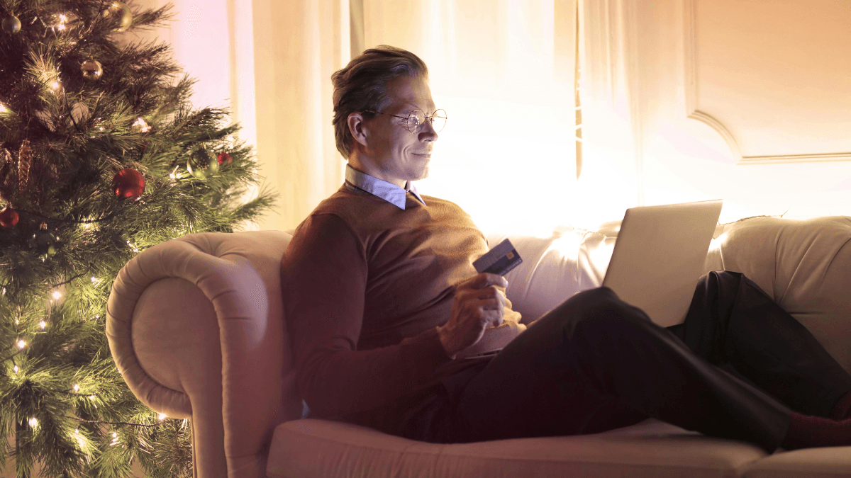 Image of Man Sitting on a Couch Online Shopping