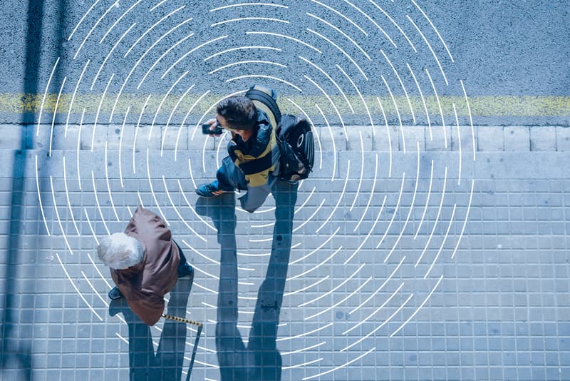 image of 2 men walking alongside each other on pavement with carat branding