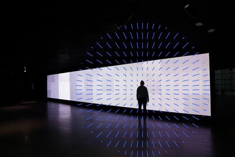 image of person looking out of long horizontal window in dark room with carat branding