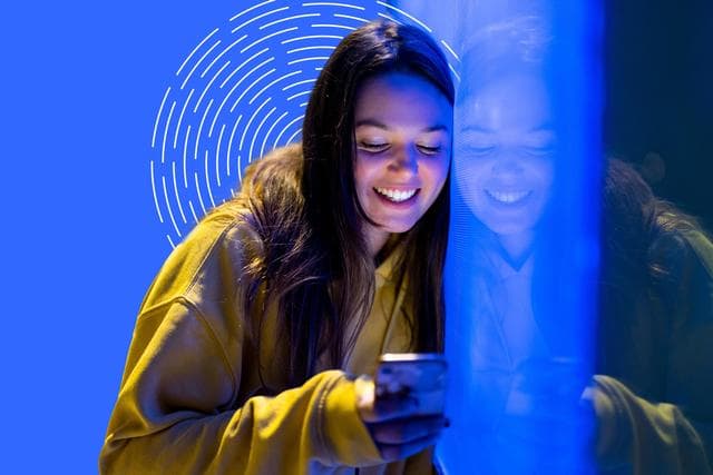 woman smiling looking at phone