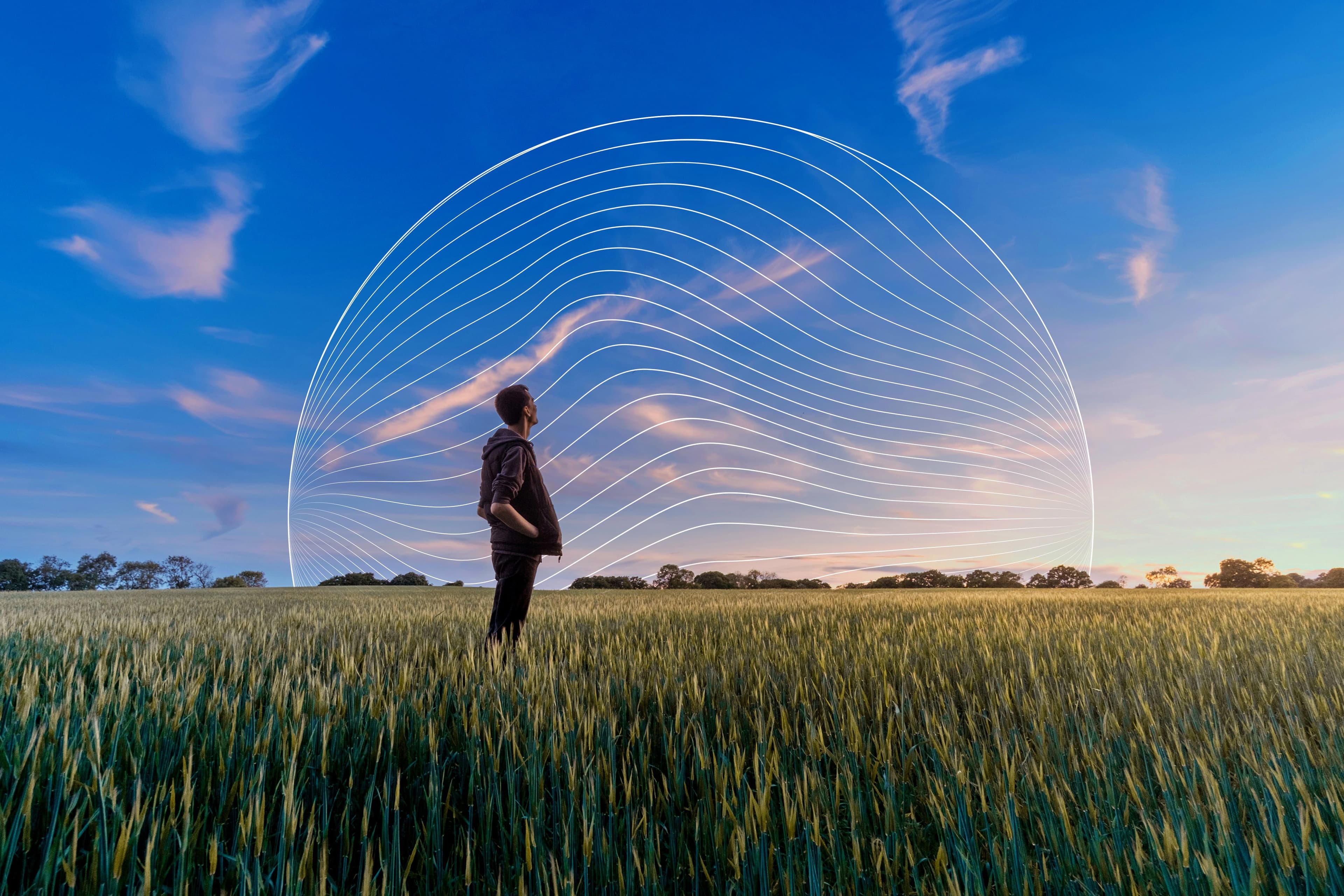 man looking at sky in a field